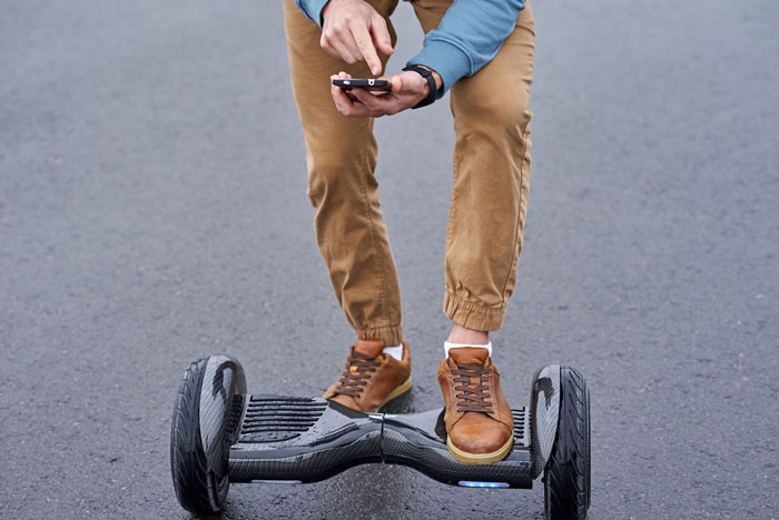 How do you play music on a hoverboard - man trying to connect bluetooth to hoverboard