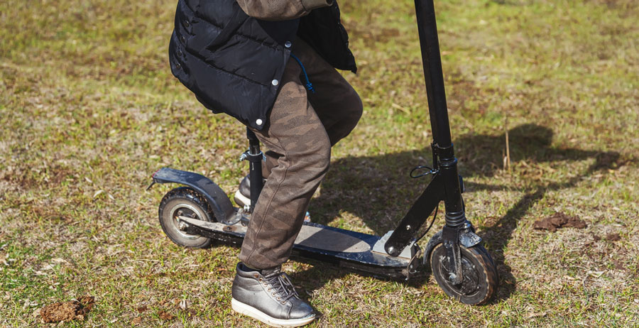 man sitting in the e-scooter with a seat