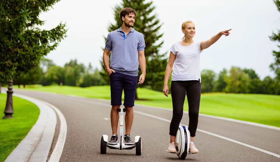 couple is riding hoverboard onewheel park
